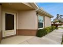 Side view of house entrance with a dark brown door and walkway at 2906 Captains Ct, Palmetto, FL 34221