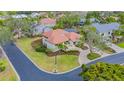 Bird's-eye view of a home with a red tile roof and lush landscaping at 3318 Bayou Sound, Longboat Key, FL 34228
