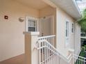 Exterior view of condo building with stairs and entrance at 4216 Central Sarasota Pkwy # 1326, Sarasota, FL 34238