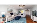 Spacious living room with comfy sofas, a large TV and wood floors at 4570 Pinebrook Cir # 303, Bradenton, FL 34209