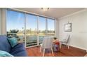 Bright sunroom with golf course view, comfy seating, and wood floors at 4570 Pinebrook Cir # 303, Bradenton, FL 34209