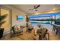 Covered patio overlooks a refreshing pool and tranquil water view at 4947 Surfside Cir, Bradenton, FL 34211