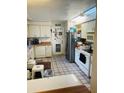 Galley kitchen with appliances and tiled floor at 5016 37Th E St, Bradenton, FL 34203