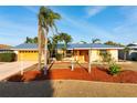 Lovely one-story home featuring a new metal roof, mature landscaping, and a well-manicured yard at 5207 Bimini Dr, Bradenton, FL 34210