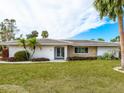Charming single-story home with stone accents and well-manicured lawn at 5560 Shadow Lawn Dr, Sarasota, FL 34242