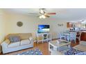 Living room with sofa, TV, and dining area at 6033 34Th W St # 120, Bradenton, FL 34210