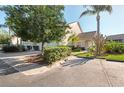 Beautiful home featuring lush landscaping, a private entrance, attached garage, and mature shade trees at 6750 Fairway Gardens Dr # 6750, Bradenton, FL 34203