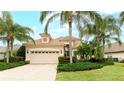 One-story home with tile roof and palm trees at 7244 Orchid Island Pl, Bradenton, FL 34202