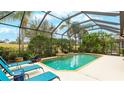 Inviting screened pool area with lounge chairs at 7244 Orchid Island Pl, Bradenton, FL 34202