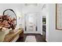 Bright entryway with a wooden console table and mirror at 7728 Rio Bella Pl, Bradenton, FL 34201