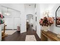 Open entryway with dark hardwood floors and access to other rooms at 7728 Rio Bella Pl, Bradenton, FL 34201