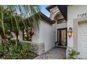 Front entrance with stone accents and a lantern light at 7728 Rio Bella Pl, Bradenton, FL 34201