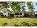 Spacious backyard with lush green grass, bird bath and a screened lanai at 807 62Nd W St, Bradenton, FL 34209