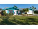 Charming one-story home with blue trim, well-maintained lawn, and attached garage at 807 62Nd W St, Bradenton, FL 34209