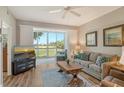 Living room with golf course view and sliding doors to balcony at 8750 Olde Hickory Ave # 9205, Sarasota, FL 34238