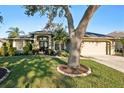 House exterior with mature trees and manicured lawn at 8818 29Th E St, Parrish, FL 34219