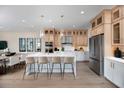 Modern kitchen with light wood cabinets, large island, and stainless steel appliances at 9985 Key Haven Rd, Seminole, FL 33777