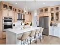 Modern kitchen with light wood cabinets, large island, and stainless steel appliances at 9985 Key Haven Rd, Seminole, FL 33777
