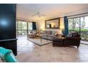 Spacious living area with tile floors and access to a balcony at 1001 Benjamin Franklin Dr # 110, Sarasota, FL 34236