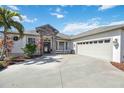 Beautiful home exterior with a stone accent, three car garage and lush landscaping at 14116 Nighthawk Ter, Lakewood Ranch, FL 34202