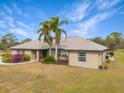 Single story house with landscaping and palm trees in front at 15409 Waterline Rd, Bradenton, FL 34212