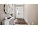 Bright and airy entryway with a stylish console table and mirror at 16008 Crofton Springs Way, Port Charlotte, FL 33953