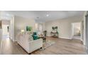 Living room features a view to the hallway and another room at 1637 Turrell St, North Port, FL 34286