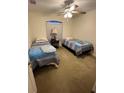 Cozy bedroom with two twin beds and ceiling fan at 1649 N Chamberlain Blvd, North Port, FL 34286