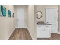 Bright entryway with white cabinets and wood-look floors at 1794 Karluk St, North Port, FL 34287