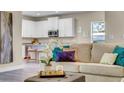 Living room with beige sofa and view of kitchen at 1794 Karluk St, North Port, FL 34287