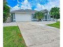 Home's exterior showcasing a large driveway and garage at 18652 Ohara Dr, Port Charlotte, FL 33948