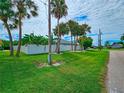 Landscaped side yard with a white vinyl fence at 18652 Ohara Dr, Port Charlotte, FL 33948