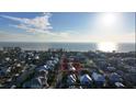 Aerial view of a beach house, showing its location near the ocean and other houses at 210 Willow Ave, Anna Maria, FL 34216