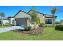 View of the home's exterior, highlighting the landscaping and architectural details at 221 Brindisi Cir, Nokomis, FL 34275