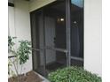 Front entry with screen door and landscaping at 376 Oak Hill Dr # 36, Sarasota, FL 34232