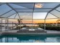 Relaxing pool and spa area with sunset view from screened enclosure at 419 Yacht Harbor Dr, Osprey, FL 34229