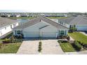 Two-story home with gray exterior, two car garage, and landscaped yard at 4337 Sunmill Ct, Lakewood Ranch, FL 34211