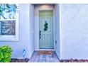 Inviting front door entrance with a fresh coat of paint and charming wreath at 4337 Sunmill Ct, Lakewood Ranch, FL 34211