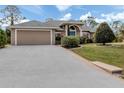 Long driveway leading to a tan house at 4590 Oakley Rd, North Port, FL 34288