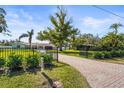 Attractive brick driveway and lush landscaping leading to the home at 504 68Th Avenue W Dr, Bradenton, FL 34207