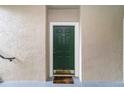 Green condo entry door with a brown welcome mat at 5180 Northridge Rd # 211, Sarasota, FL 34238