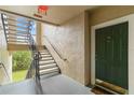 Interior condo stairwell with green door visible at 5180 Northridge Rd # 211, Sarasota, FL 34238