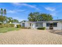 House's front view showcasing its design and parking at 5823 26Th W St, Bradenton, FL 34207