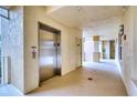 Residential hallway with elevator and access to condo units at 6450 Watercrest Way # 304, Lakewood Ranch, FL 34202