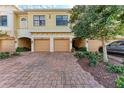 Townhome exterior with a brick driveway and landscaping at 7325 Skybird Rd, Bradenton, FL 34209