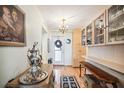 Entryway with hardwood floors, built-in shelves, and antique furniture at 33 S Gulfstream Ave # 808, Sarasota, FL 34236