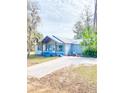 Newly renovated light blue house with a paver driveway at 10607 3Rd St, Thonotosassa, FL 33592