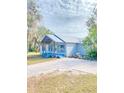 Newly renovated light blue house with a paver driveway at 10607 3Rd St, Thonotosassa, FL 33592