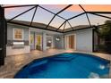 Inviting pool area with outdoor kitchen and covered patio at 14333 Stirling Dr, Lakewood Ranch, FL 34202