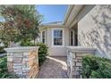 Inviting entrance with stone pillars and a brick-paved walkway at 1910 Scarlett Ave, North Port, FL 34289